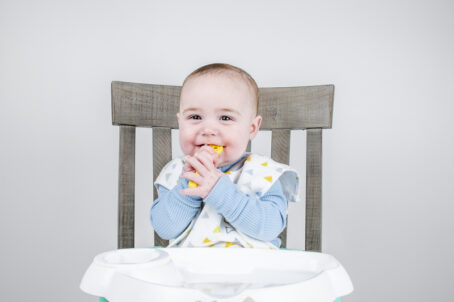 Happy baby using baby spoon set